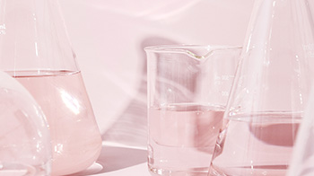 Erlenmeyer flasks, a beaker, and a Florence flask in a pink setting