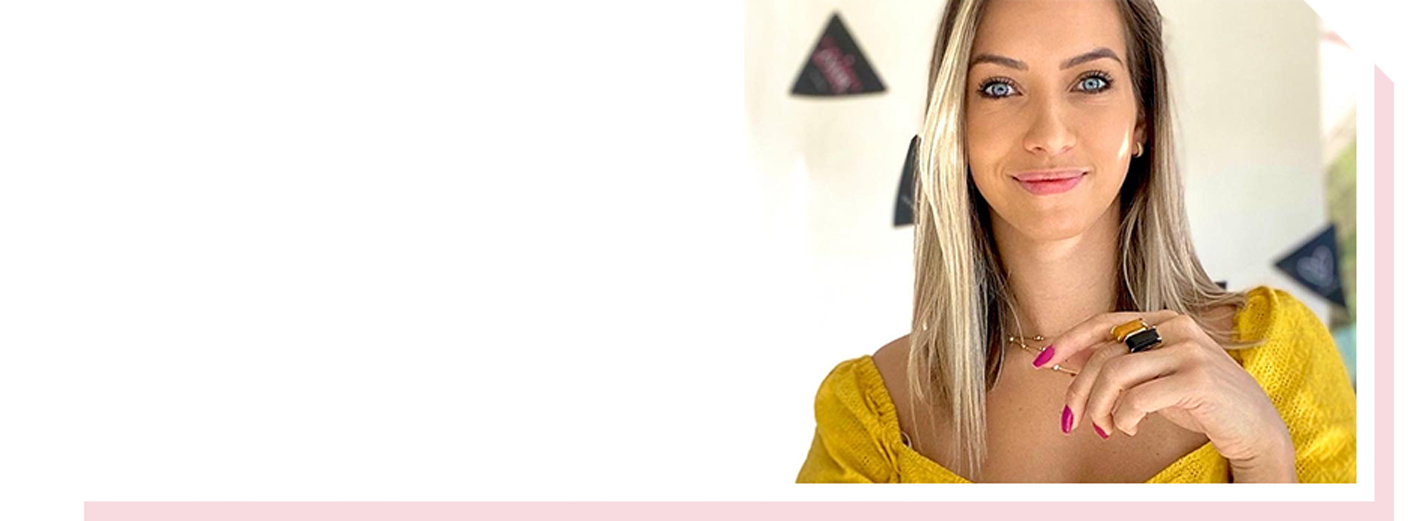 Image of woman in yellow top with slight smile