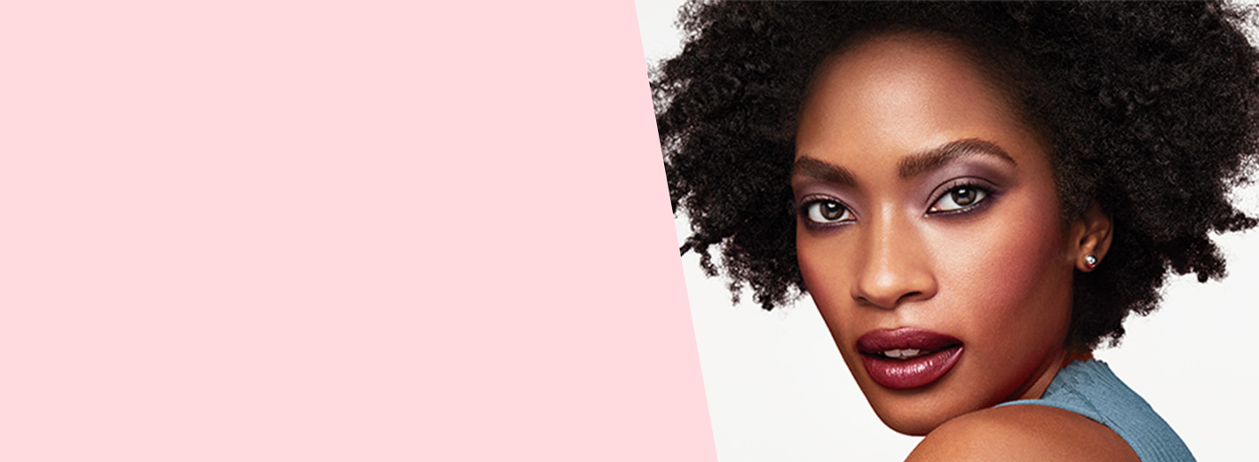 Close up of model wearing Plum Passion makeup artist look from Mary Kay against a white background.