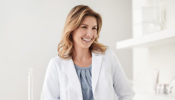 A picture of Dr. Cristi Gomez, Director of Product Safety and Environmental Toxicology, smiling in a scientific setting