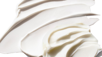 Creamy product rubs smeared over a solid background