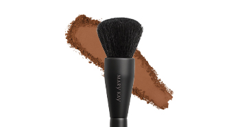 Powder foundation brush with bronze smudge powder in background