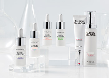 Clinical Solutions Family with Retinol 0.5 Set and Boosters with a background with scientific equipment