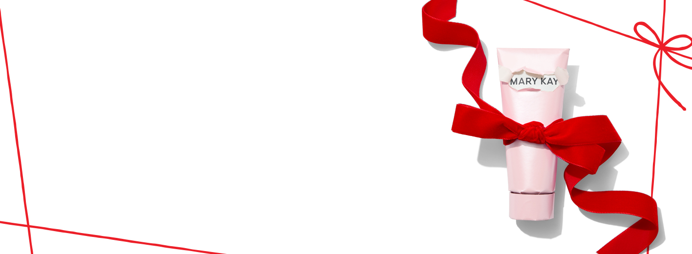 Mary Kay product covered in wrapping paper with a red bow on a plain white background with a geometric red pattern in each corner