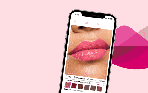 pale pink background with a phone showing image of lips with pink lipstick